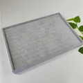 Close-up of a grey velvet 100-slot jewelry display tray for rings and small earrings - Gray Ice Velvet