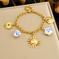 Detailed view of gold chain bracelet with sun pendants and blue floral ceramic heart beads - Gold Pendant Bracelet(B1805)