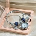 Detailed view of silver beaded charm bracelet watch with blue beads in a pink gift box - Silver Wing Bangle