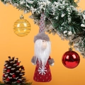 Detailed view of red knitted Christmas gnome ornament with festive hanging balls - Santa Claus