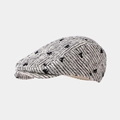 Detail of tweed newsboy cap with black floral jacquard pattern and textured knit - Newsboy Cap