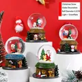 Close-up of 6.5cm Santa Claus crystal ball with LED lights and automatic snow feature - Style 65 Orange Floral / Style F