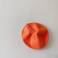 Detail of soft orange knitted wool beret fabric texture and vibrant candy color - Orange