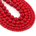 Macro view of bright red round natural stone beads in various sizes for jewelry making - Red Shell Pearl