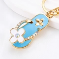 Blue flip-flop keychain with gold-tone alloy base and sparkling rhinestone floral accents - Blue Clover Slippers
