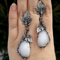 Vintage silver vine leaf earrings featuring white teardrop opal stones in a natural style - White