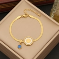 Detail of gold snake chain bracelet featuring evil eye and sun charms on a beige box - Sun Coin Evil Eye Style (5#)