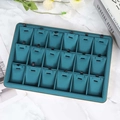 Teal jewelry display tray with 18 hooks for necklaces on white marble background - 18 Slot Pendant Tray Green