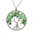 Close-up of handmade Tree of Life pendant with green natural crystal stones and silver wire - Green / Aventurine