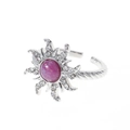Macro shot of silver sunflower ring featuring pink purple center stone and crystal accents - Ring - Silver
