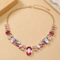 Detail of colorful oval and pear cut crystals on a gold-plated link necklace - Pink (KC Gold Stem)