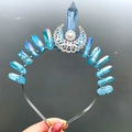Macro detail of iridescent blue crystal shards and moon charm on a handmade crown headband - Crown Hairband / Light Blue