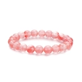 Close-up of pink natural stone beaded bracelet with smooth round quartz beads on white background - Orange Stone