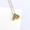 Close-up of 18K gold letter P pendant necklace with cubic zirconia on a bead chain - Letter P