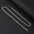 Close-up of silver and gold twist chain necklace with lobster clasp on black leather - Necklace 55CM / Silver-Gold Mix