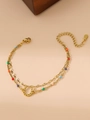 Close-up of double-layer gold horseshoe bracelet with colorful beads and lobster clasp - Horseshoe Pendant / Gold