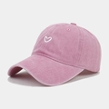 Detail view of washed pink cotton baseball cap with white heart embroidery - Pink