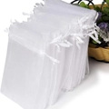 Stack of white organza drawstring gift bags made of translucent mesh fabric for parties - 10*12cm White Organza Bag