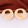 Detail of round hollow acrylic and hammered metal earrings in cream and gold - Gold-Beige