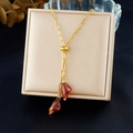 Vintage gold-plated stainless steel necklace with irregular brown amber pendants on a box - Gold Amber-Like Double Pendant Style (N3987)