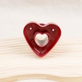Red heart-shaped plastic donut mold for baking on a light textured wooden surface - Red Heart Donut