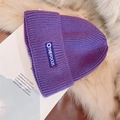 Detailed texture of purple knit beanie featuring THE FOCUS embroidered logo and thick yarn - Letter Label Style / Purple