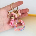 Detail of Letter D resin keychain with colorful heart sequins, pink butterfly and tassel - Butterfly Tassel 8-Shape Buckle / Letter D