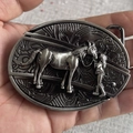 Vintage silver western belt buckle featuring embossed horse and girl artwork - Cowgirl