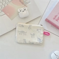Close-up of fabric coin purse with blue cat print and pink handle on a desk - Printed Cat White