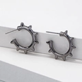 Minimalist punk gear earrings in gun black finish displayed on a white product stand - Black Nickel