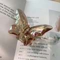 Iridescent butterfly hair claw clip with holographic resin finish on book page - Iridescent Khaki