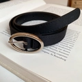 Slim black leather belt with silver oval buckle placed on a vintage book - 72# Waist Chain - Black
