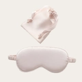 Pink faux silk sleep mask and matching drawstring pouch set on a beige background - Champagne Pink