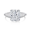 Macro shot of silver ring with emerald cut center stone and trapezoid side diamonds - White Rectangle Cut Three Stone Style