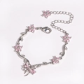 Silver bracelet featuring pink cherry blossoms and cubic zirconia with bow accent - Pink White Gold