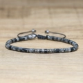 Adjustable woven bracelet featuring cylindrical grey imperial stone beads and black cord - No.62 Labradorite