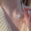 Elegant silver lock necklace with pink gemstone and tassel detail on model neck - Silver Lock Tassel Necklace (XL1639)