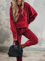 Detailed view of red velvet tracksuit texture on model with industrial wall background - S / Red