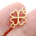 Golden clover-shaped stainless steel pendant connector held on a fingertip - DY748 Double-Hole Clover / Gold