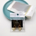 Orecchini dorati con gemme bianche su cartoncino Fashion nero con perni in argento 925 - 7*14 Busta Trasparente (Senza Card)