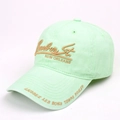 Detail view of mint green washed baseball cap with Bourbon St embroidery and air vents - Green