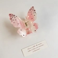 Macro detail of gradient pink butterfly hair claw with sparkling rhinestone embellishments - Pink