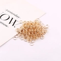 Close-up of numerous gold-colored metal jump rings for DIY jewelry making - 4mm (Approx 400pcs/20g) / KC Gold