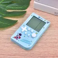 Blue retro handheld Tetris game console with space theme pattern on wooden surface - Astronaut / Cloud Blue