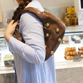 Vintage brown shoulder bag with gold rivets and crescent shape shown on model - Coffee