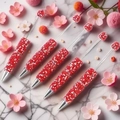 Five sparkling red rhinestone beaded pens on a minimalist white marble background - Red