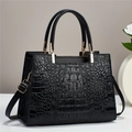 Classic black crocodile pattern handbag with elegant gold hardware and dual handles - Black