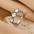 Adjustable silver bow ring featuring iridescent lava texture and three opal stones - Silver Lava Opal Open Ring (X205)