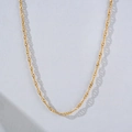 Close-up of elegant gold water wave chain necklace with minimalist metallic luster - Gold