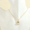 Close-up of gold chain necklace with white enamel bells and colorful zircon pendant - White Double Bells